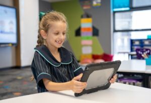 A girl works on a computer in the classroom.